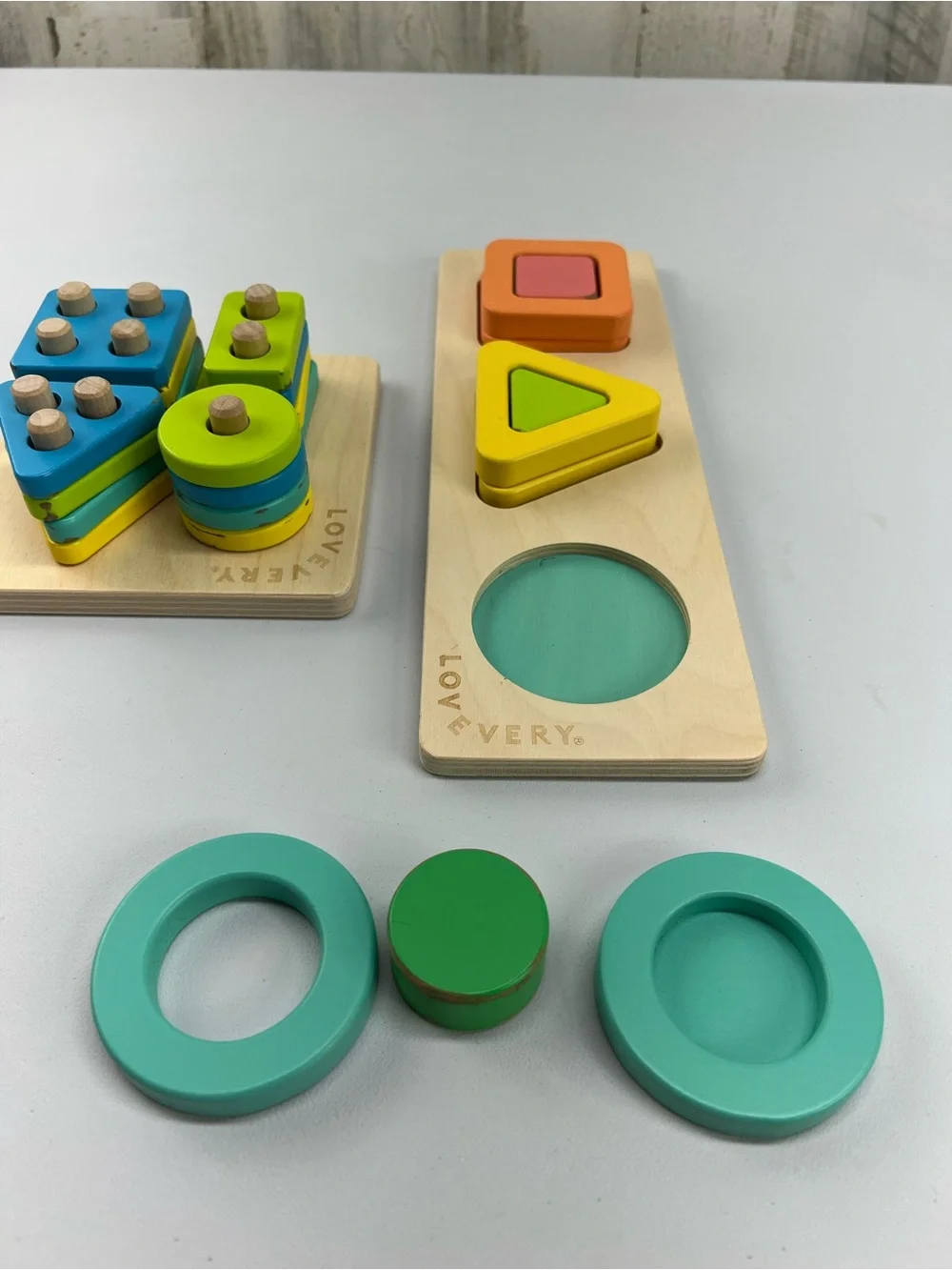 Lovevery Lot of 2 Puzzles Geo Shapes and Sort & Stack Peg Puzzle Montessori Toys